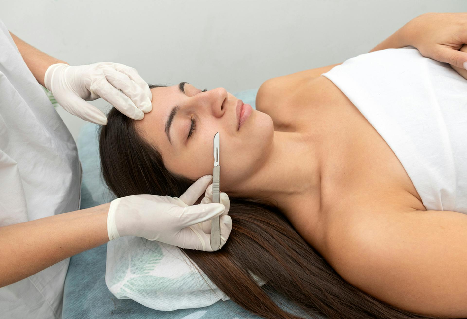 A woman receiving dermaplaning