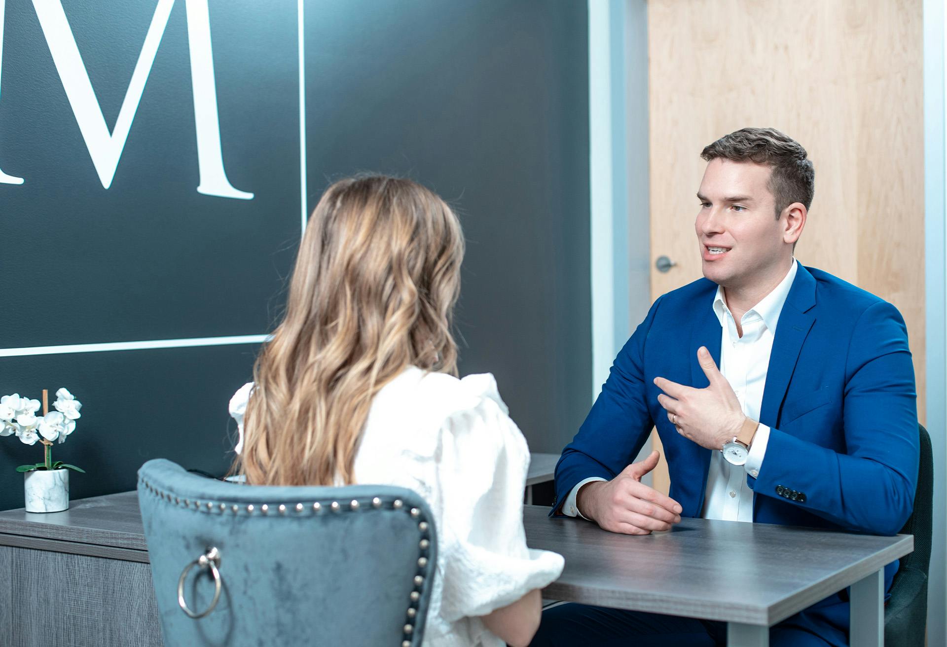 Dr. Gardenier speaking with a patient at his desk