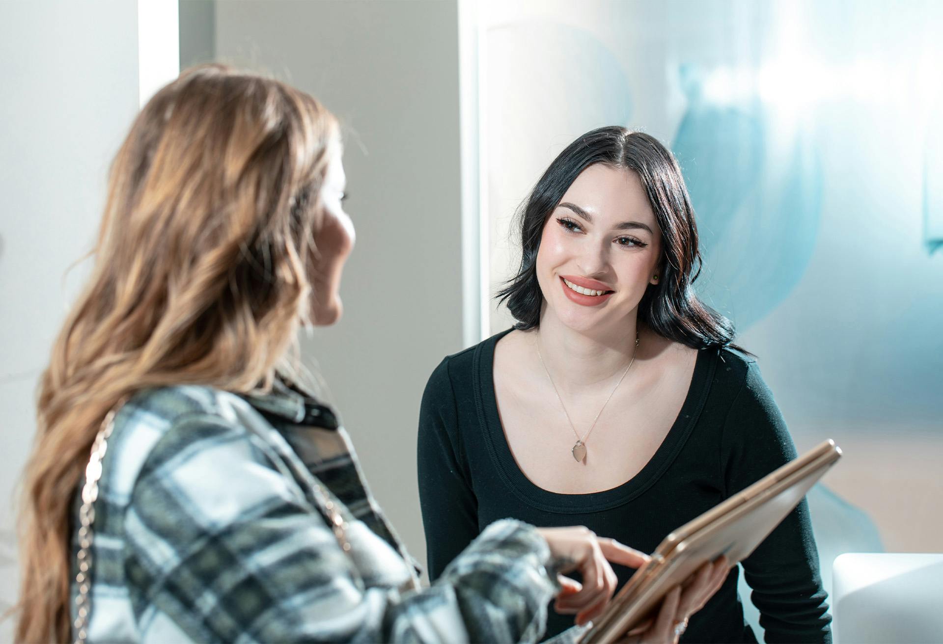 A Maine Plastic Surgery staff member speaking with a patient
