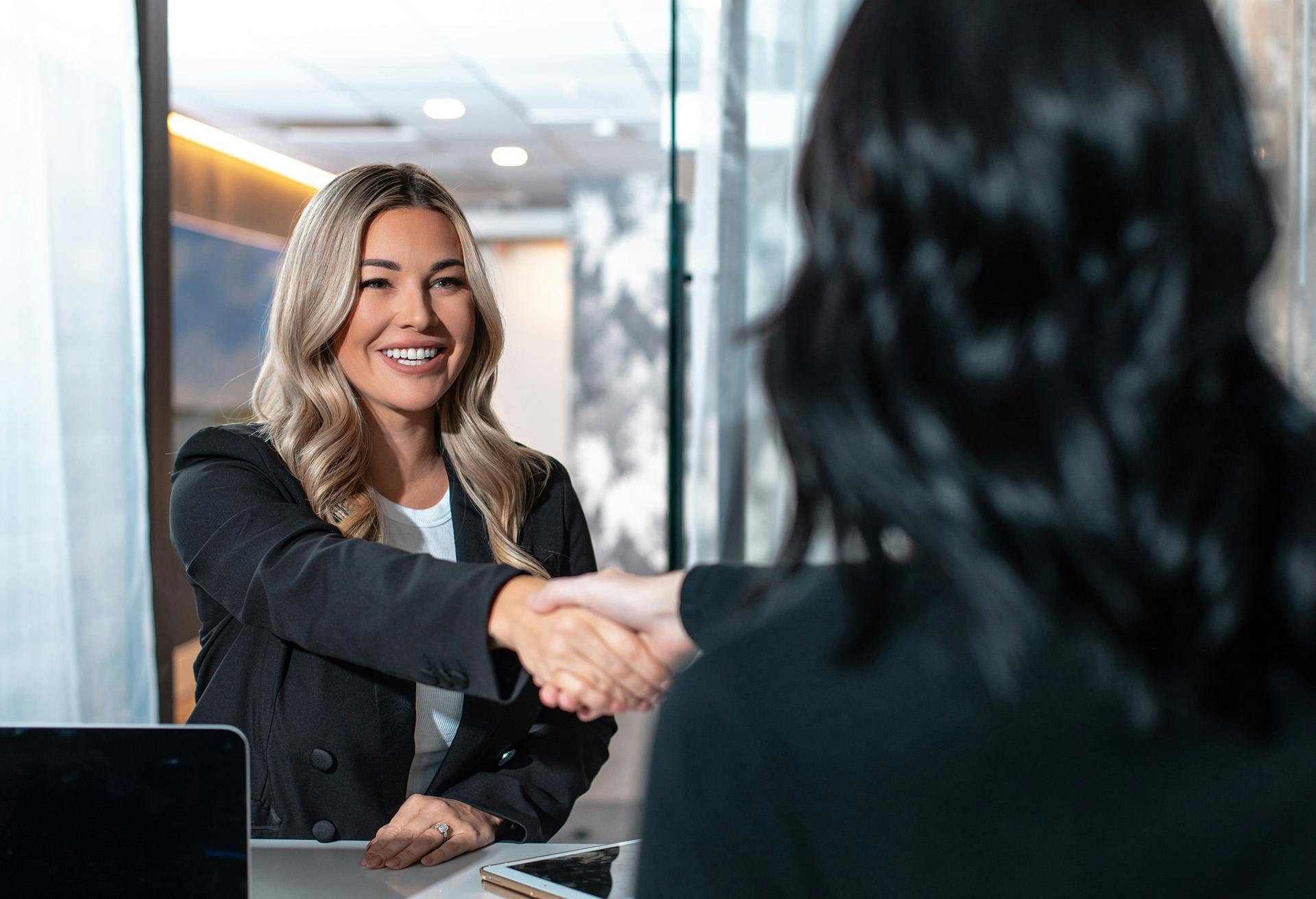 Women shaking hands with each other