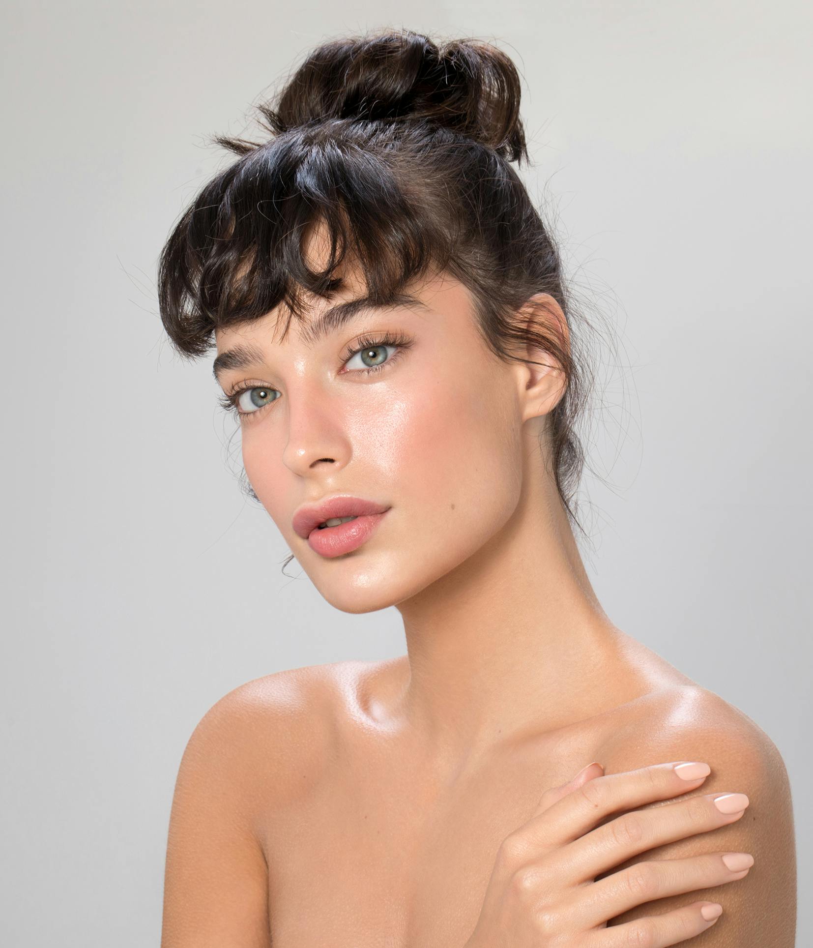 woman with clearn skin and her hair in an updo
