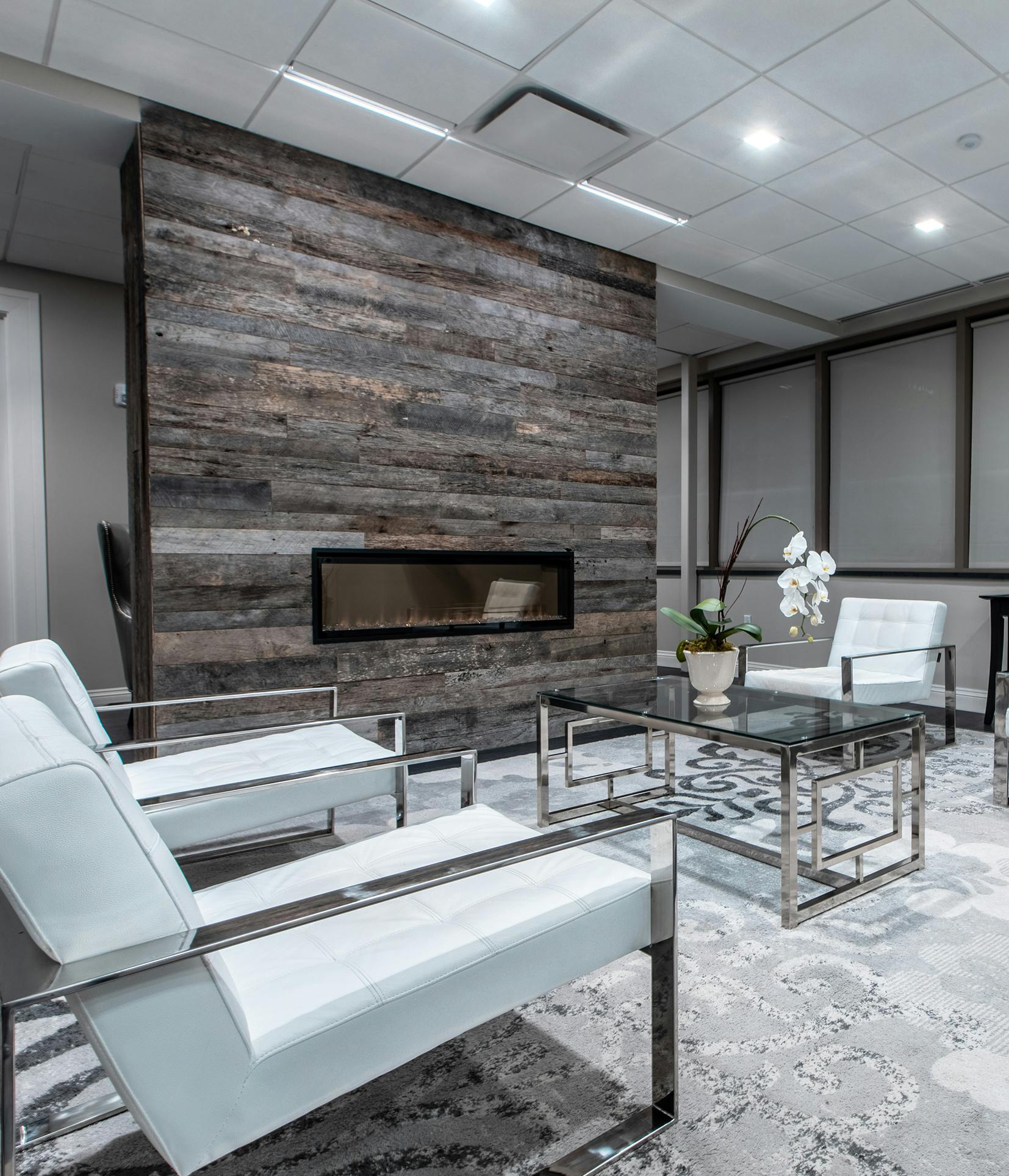 there is a room with a fireplace and chairs in it