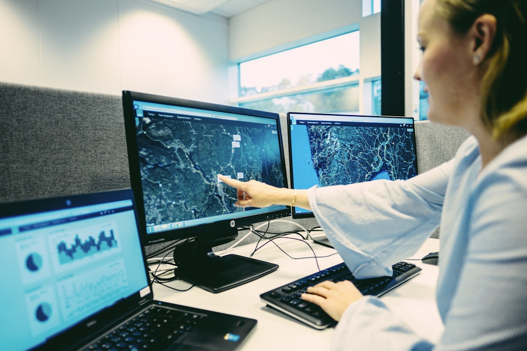 Woman pointing to data on screen