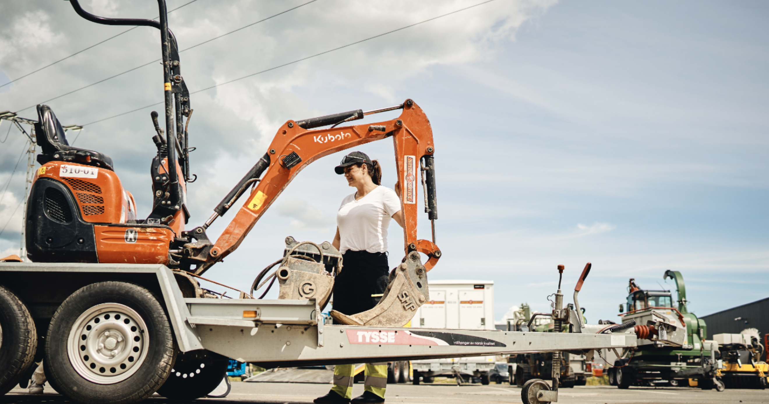 Women next to a small digger
