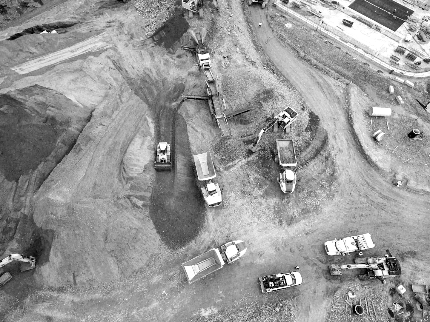 Construction site with multiple plant and machinery in black and white