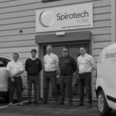 Men infront of their business Spirotech with company vehicles