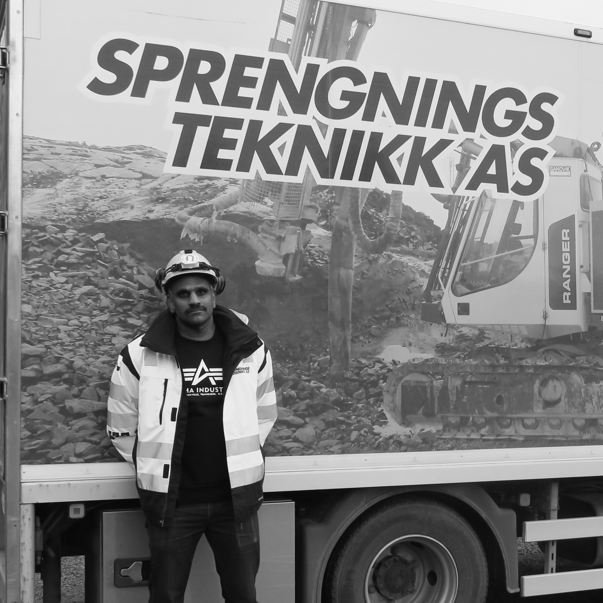 Worker in front of van with company name