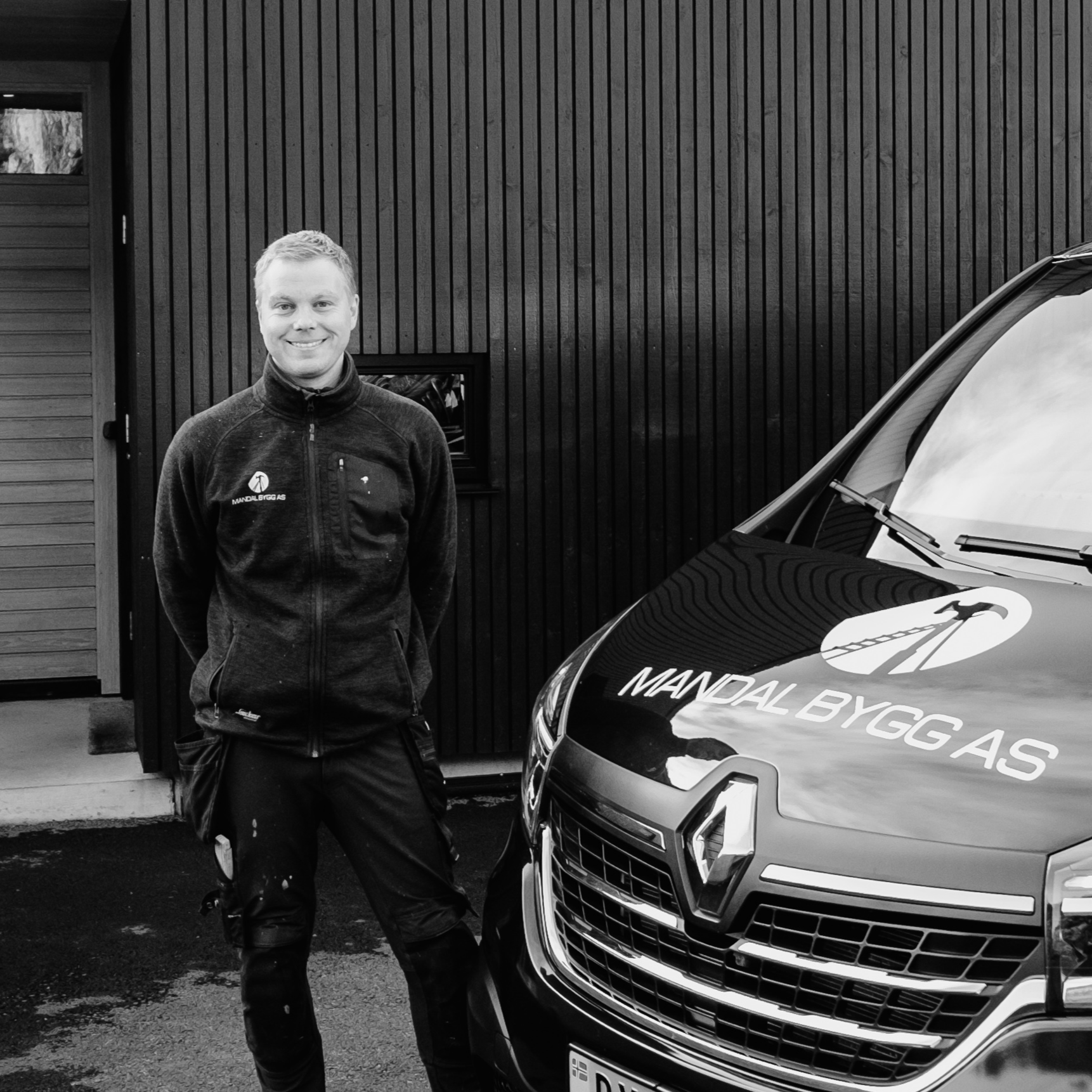 Man next to van infront of newbuilt house