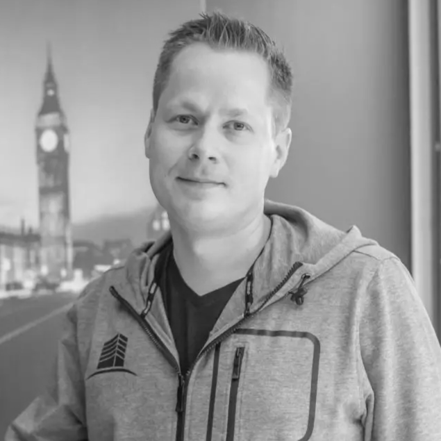 man in office building black and white looking at the camera in hoodie