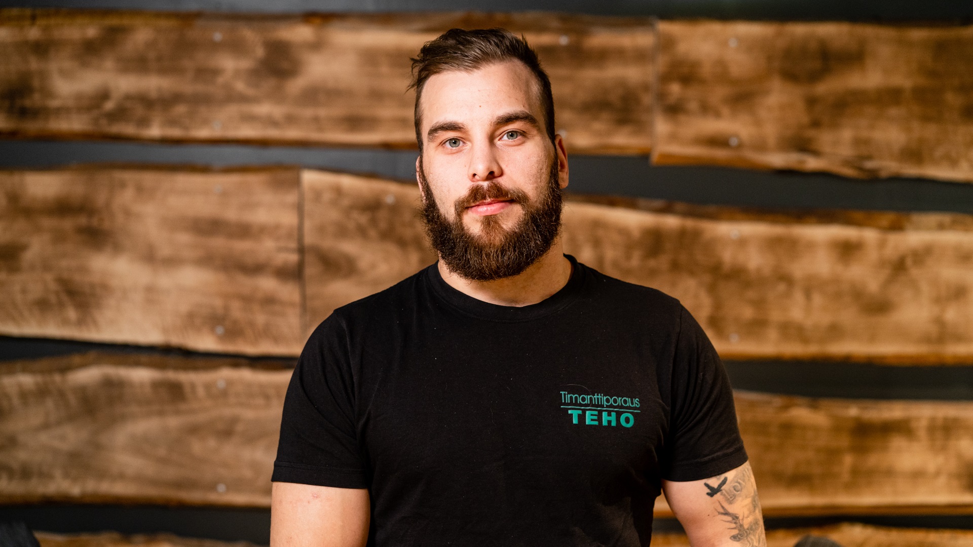 man in front of wooden wall teho oy