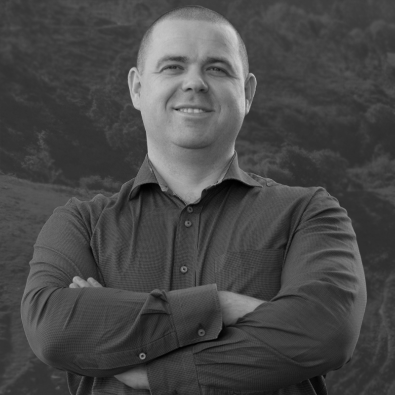 Man with arms crossed smiling black and white