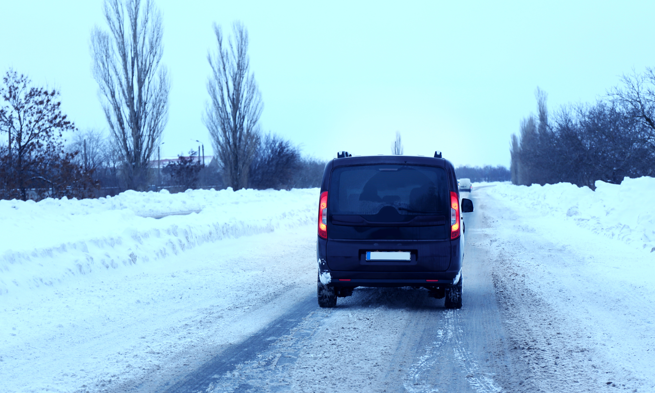 black van driving on snowy roads