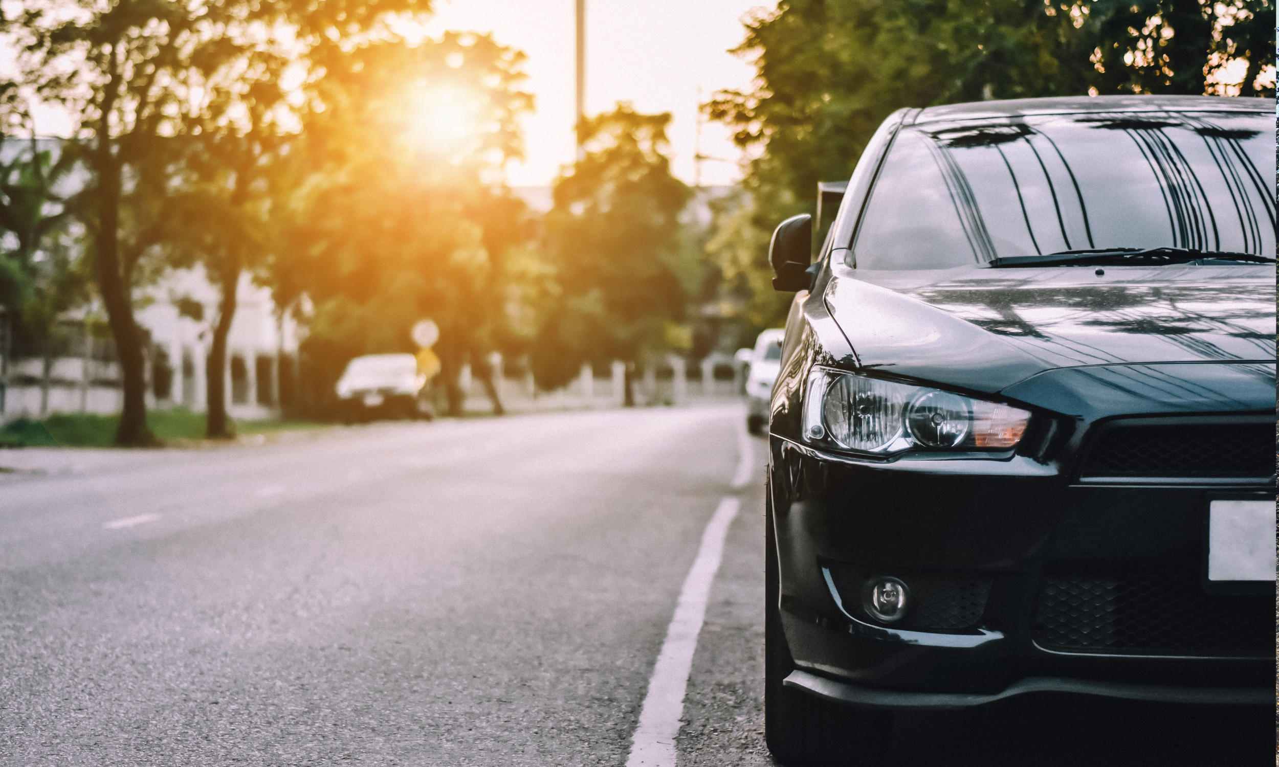 black car on residential street