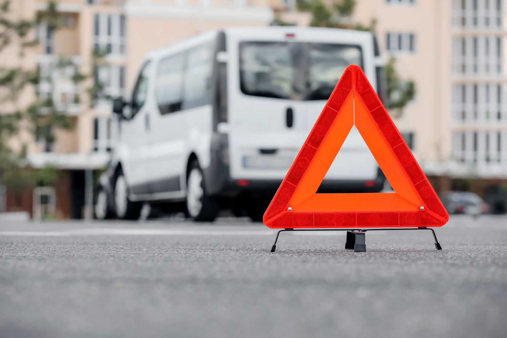 warning triangle with white van in the background