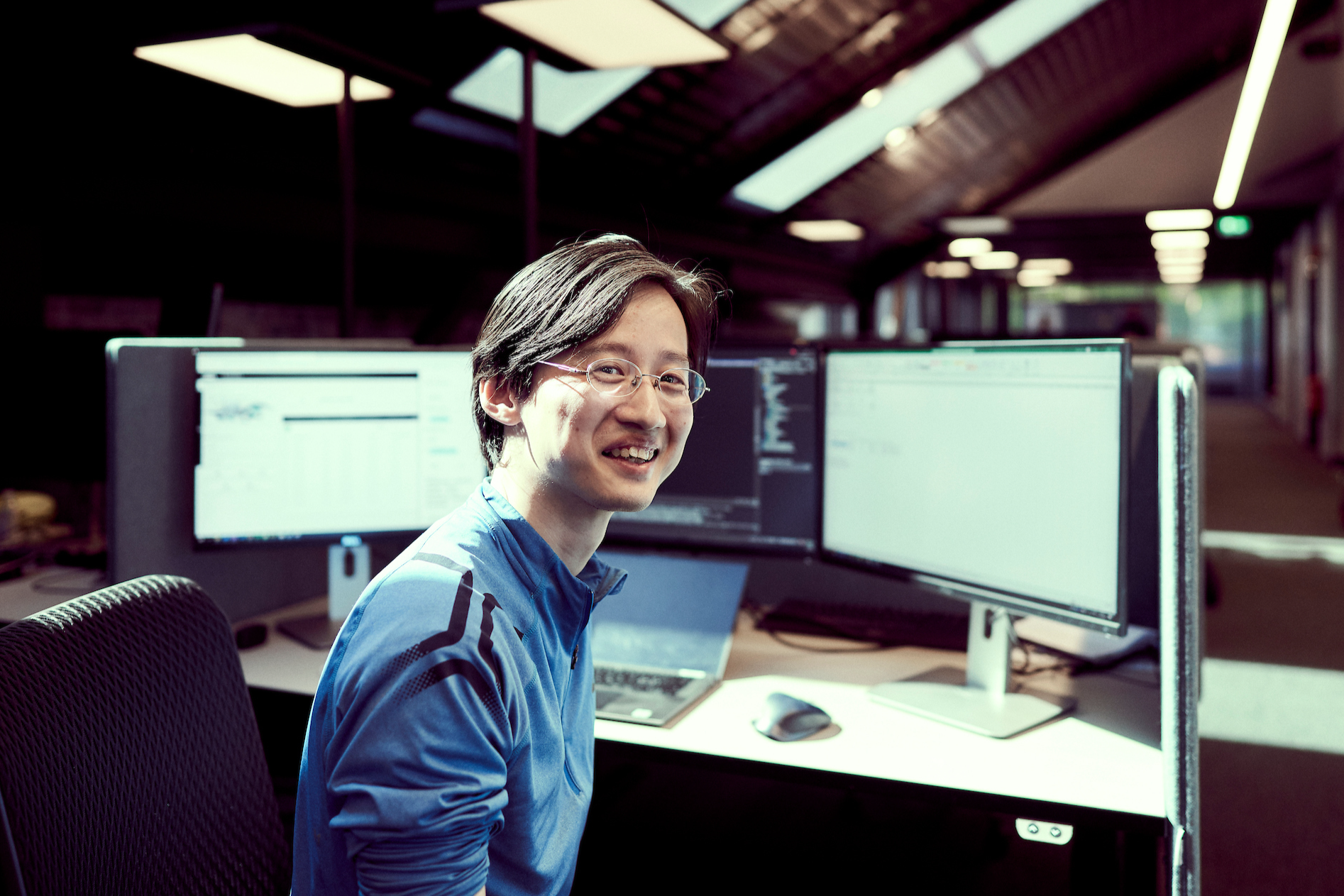 man sitting at desk in office environment