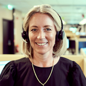 Woman with headset smiling at camera