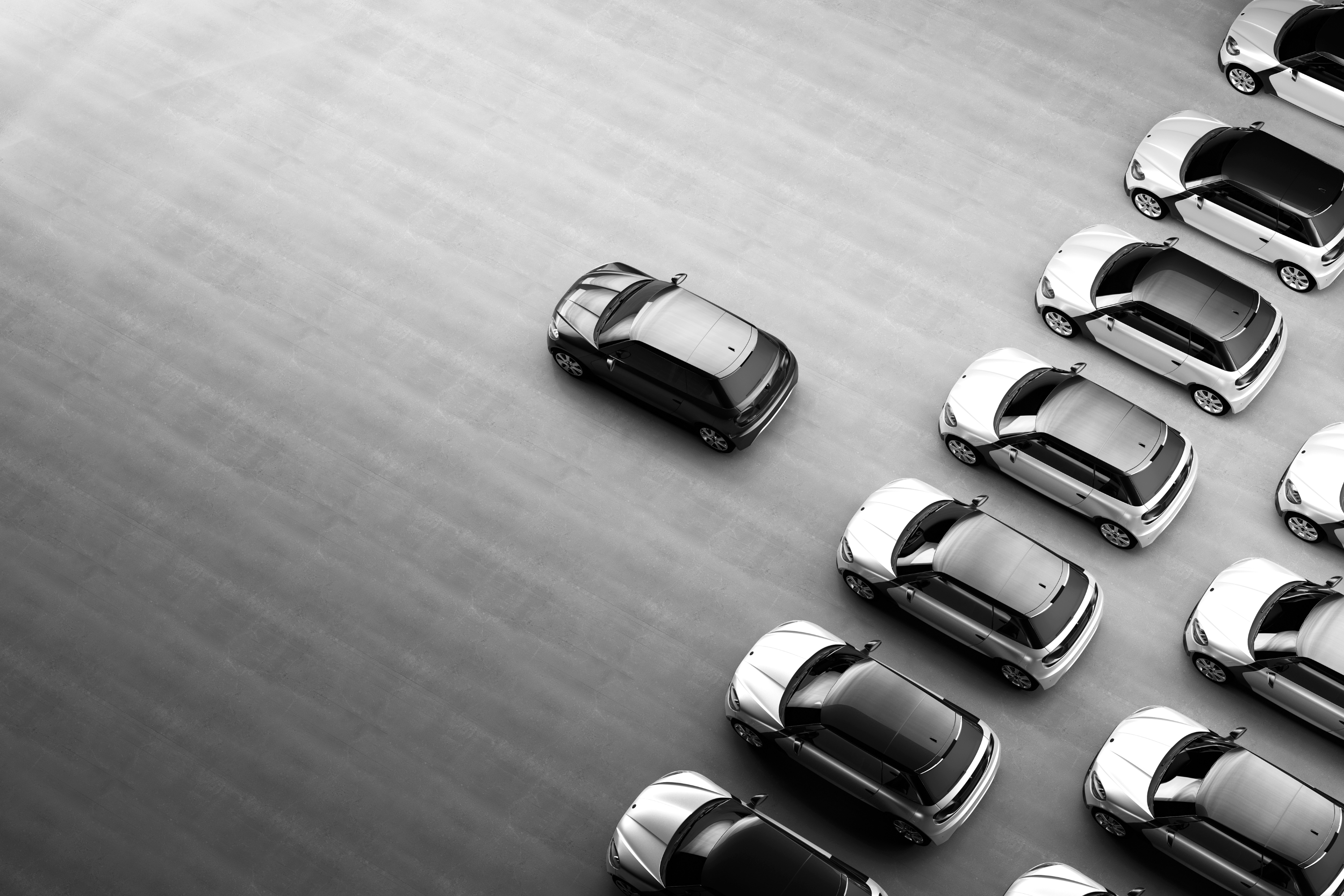 Black and white image with lots of the same car all in a row.