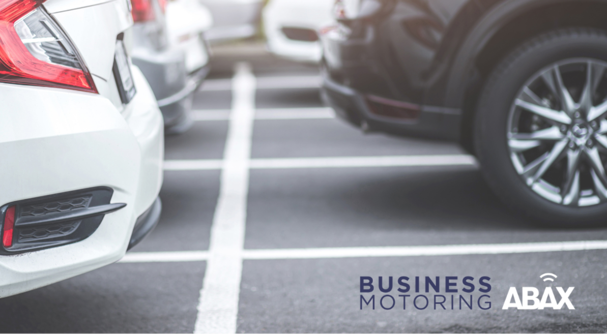 Close up shot of company cars in car park with Business Motoring and ABAX logos
