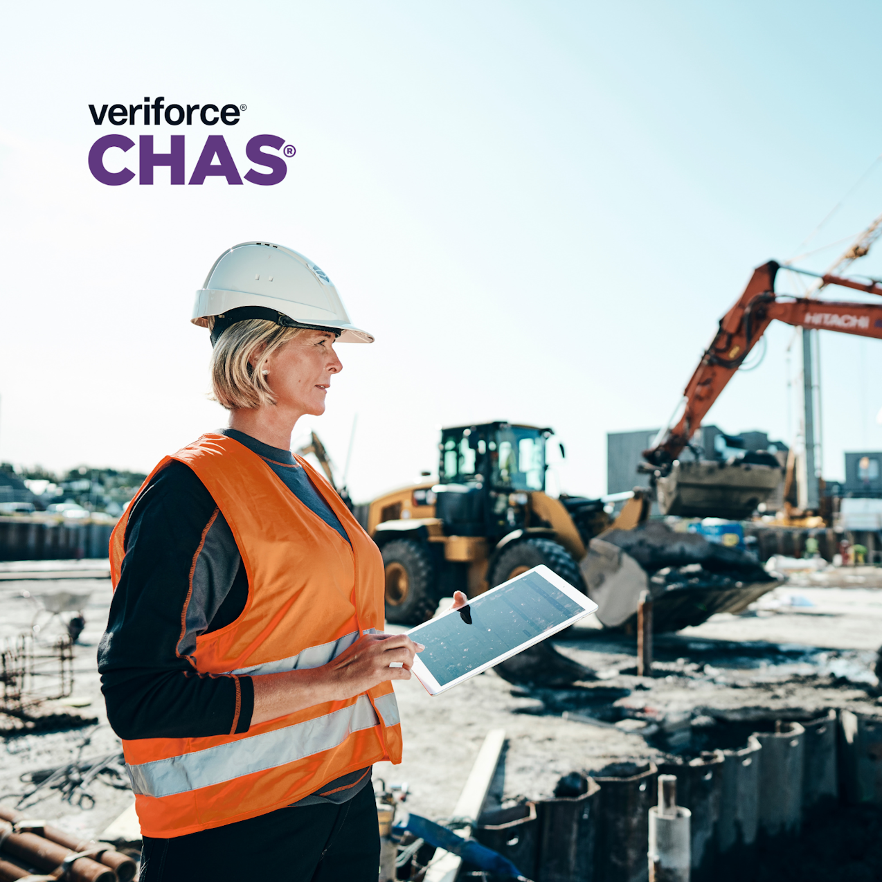 Woman in construction hard hat, managing construction site