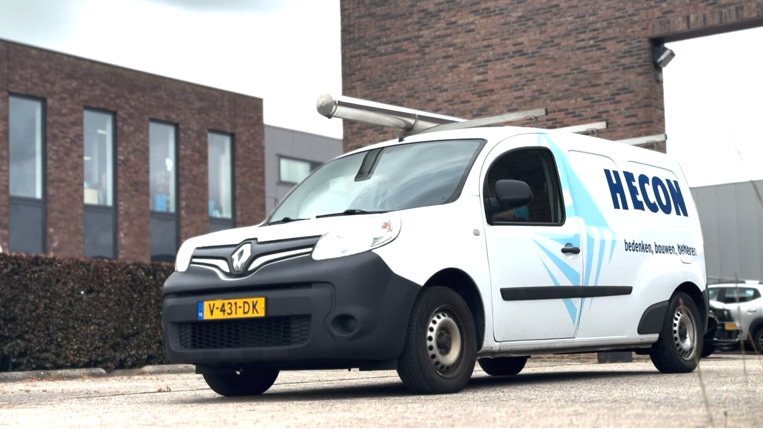 White van with Hecon signage driving out of car park.