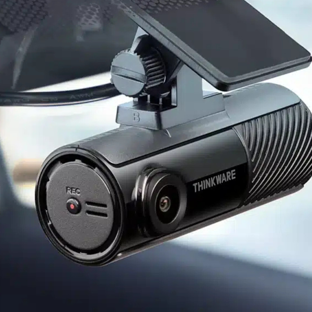 Black dash cam mounted in vehicle