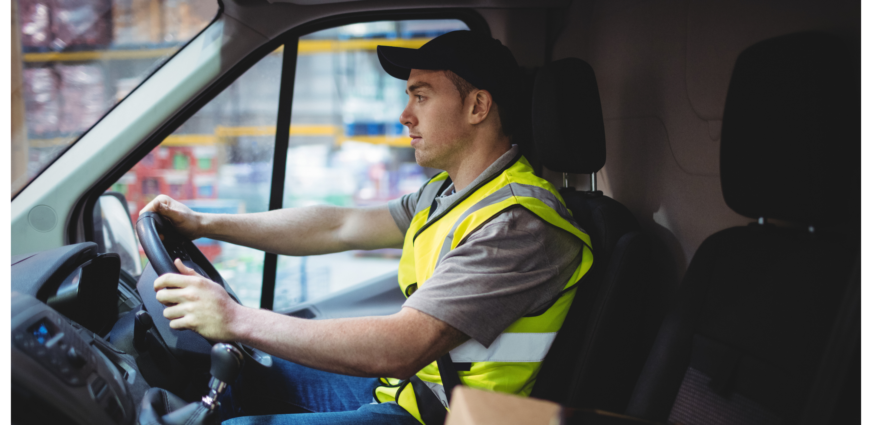 Man in yellow high vis driving van