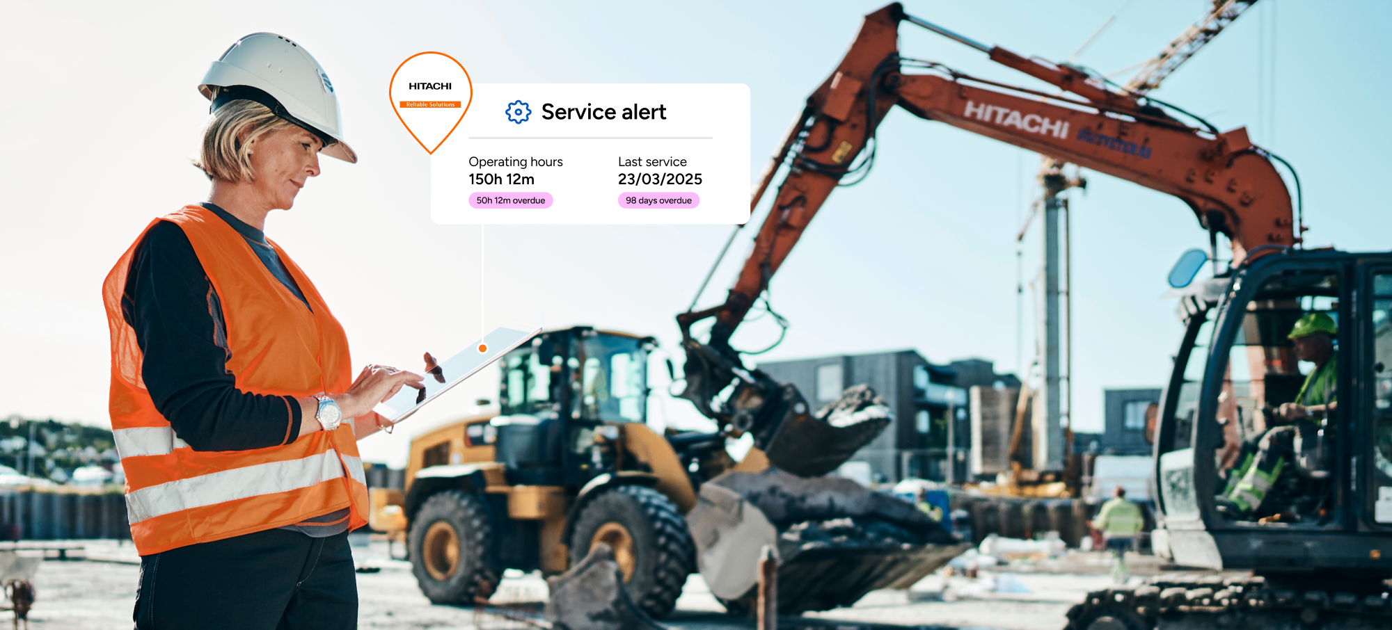 Worker on construction worksite managing heavy plant equipment in high vis and hard hat