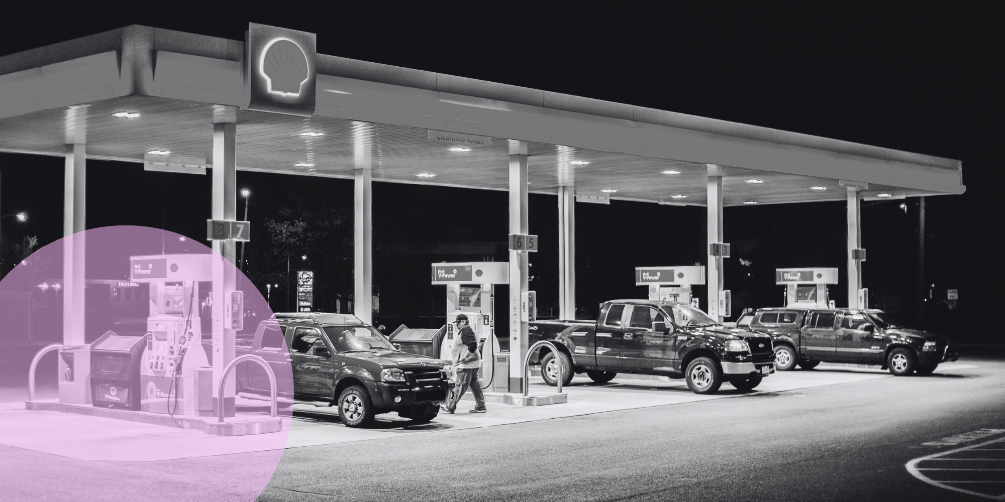 UK fuel station in black and white with 3 trucks on the forecourt and a pink decorative circle graphic overlay