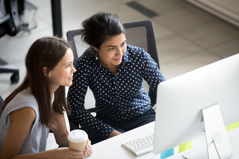 two women looking at a pc screen