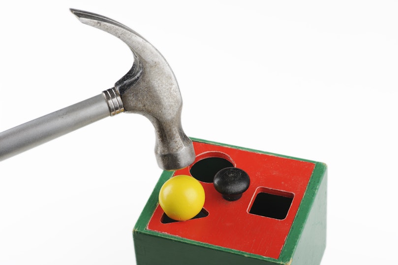 Hammering a round peg into a triangular hole