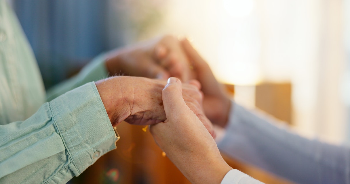 Young carer holding hands with older woman