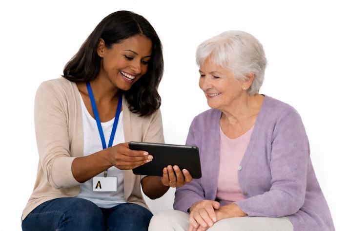 Young black female charity worker with older white female client in mauve