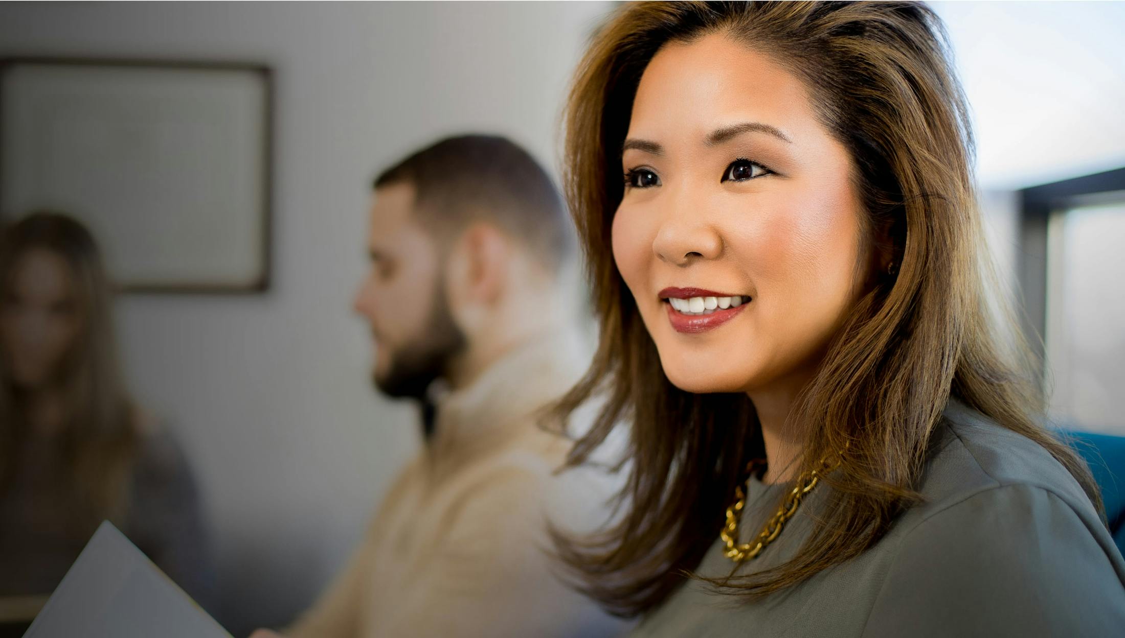 Woman smiling while waiting in a lobby