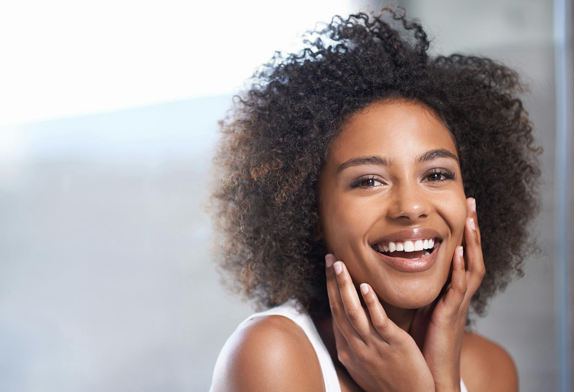 Woman Smiling with her Hands on her Cheeks
