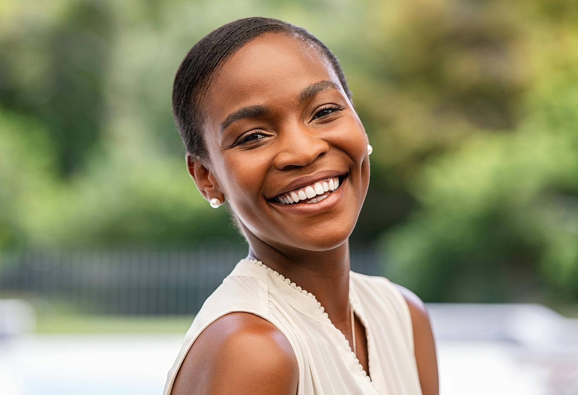Woman with Short Hair Smiling over her Shoulder