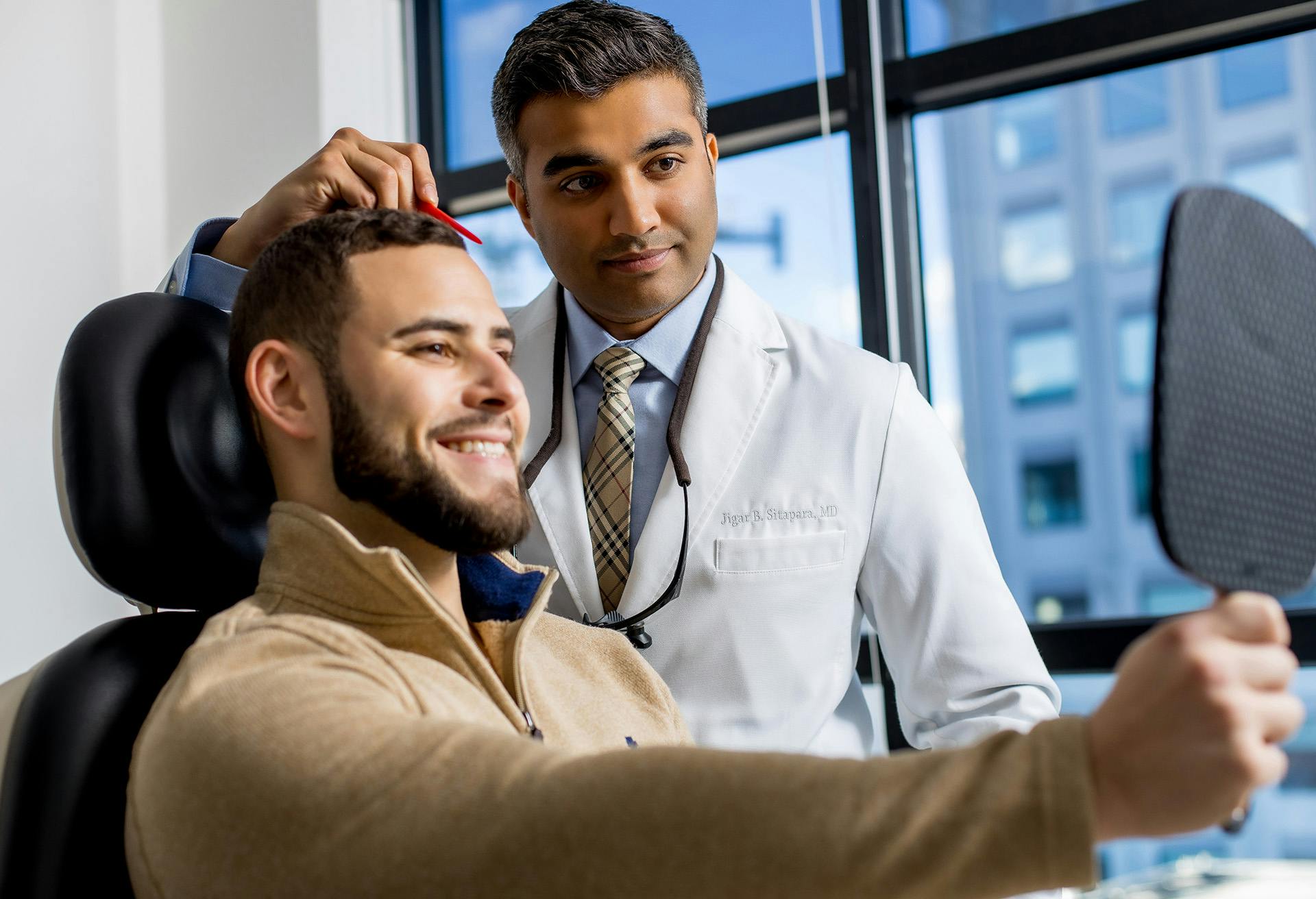 Doctor and Patient looking at the Patient's Face in the Mirror