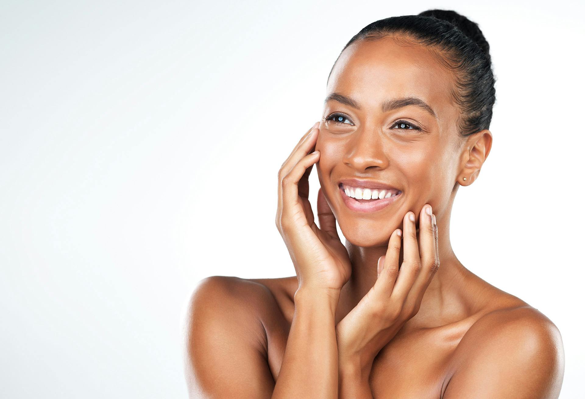 Woman Looking Towards the Camera with her Hands on her Face