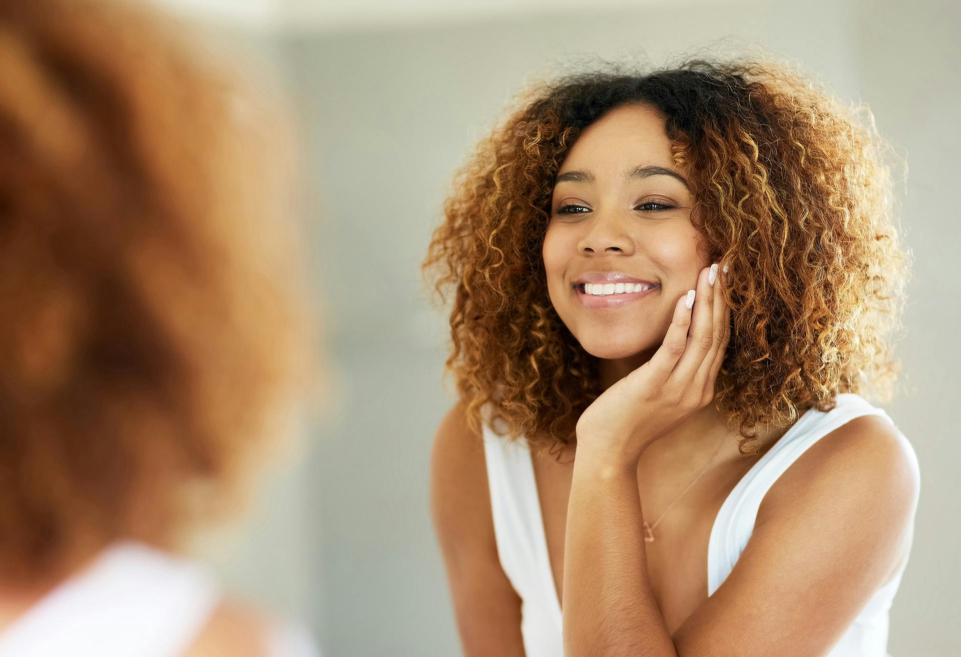 Woman Smiling in the Mirror