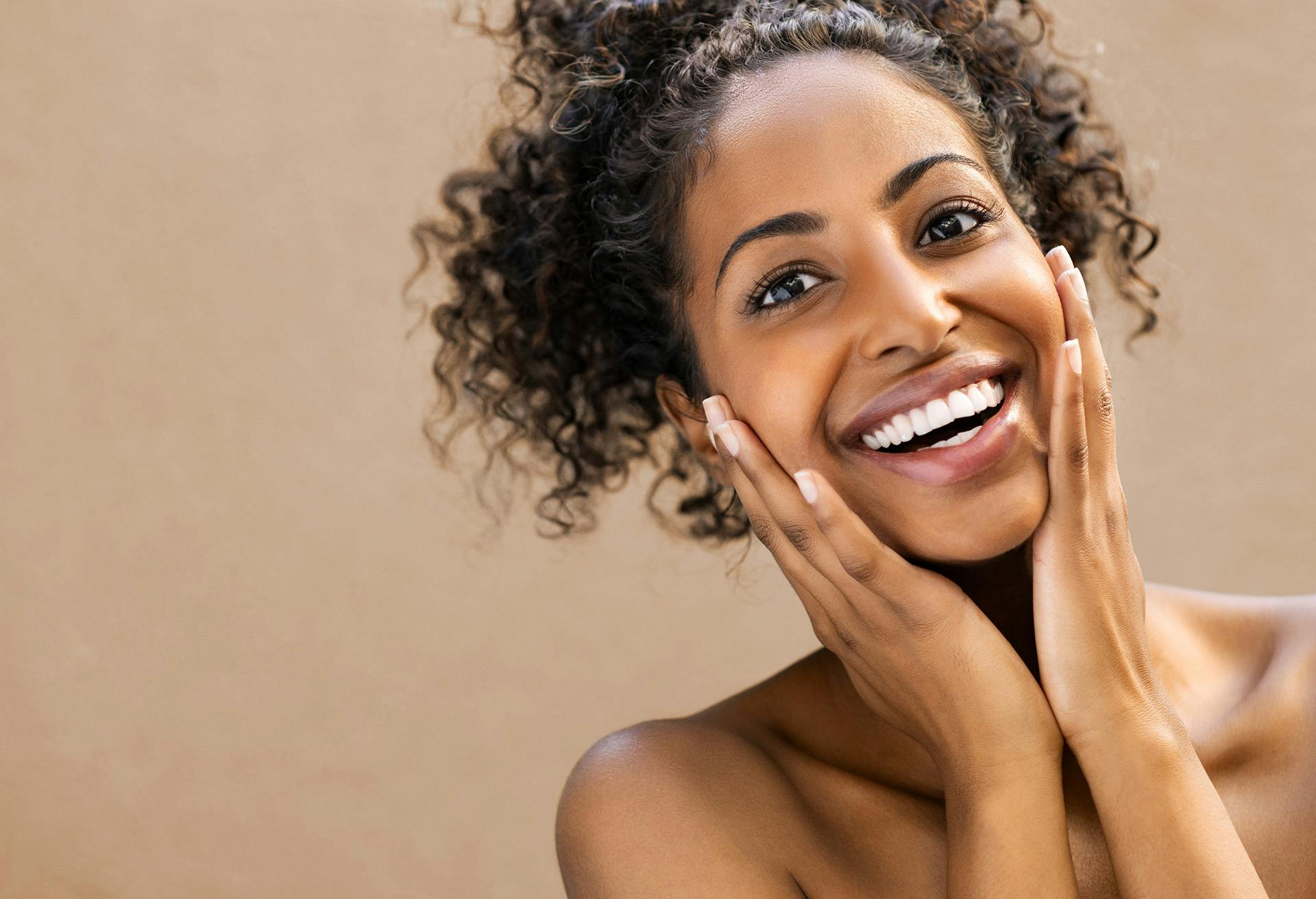 Woman Smiling with Hands on her Cheek