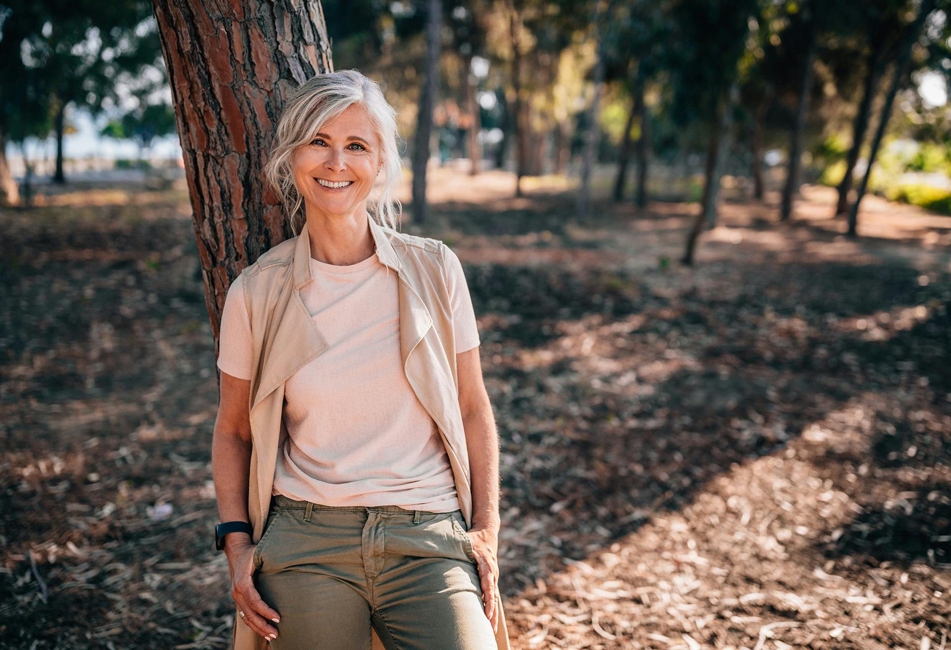 Older Woman Leaning Against a Tree