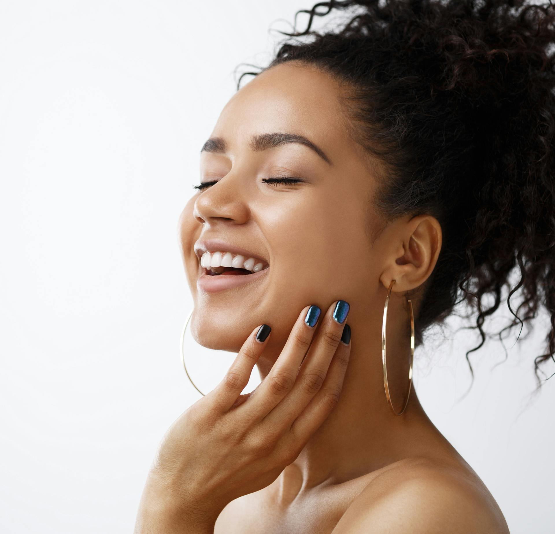 Woman with Smiling with Ponytail and Hoop Earings