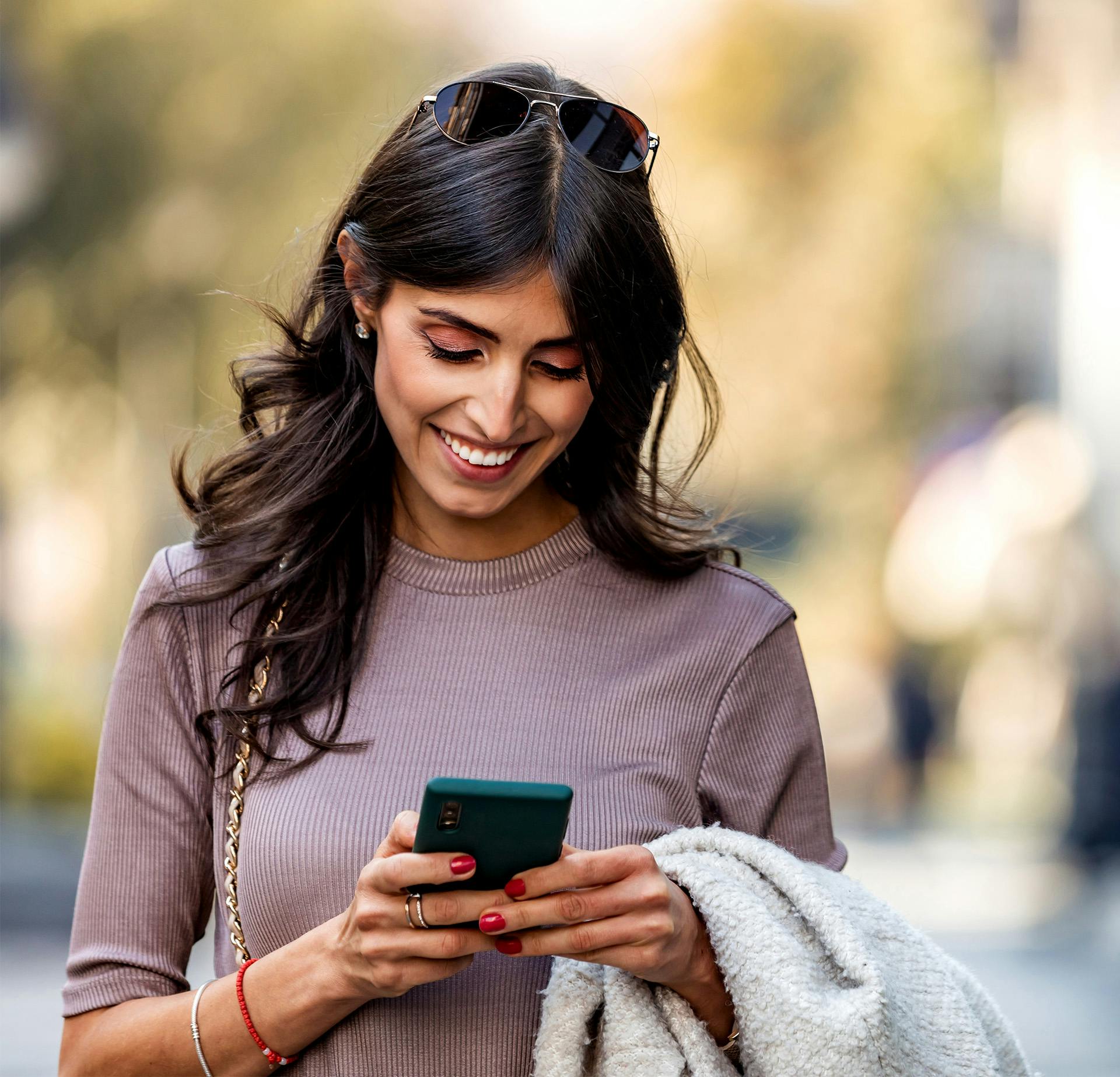 Woman Smiling Looking at her Phone