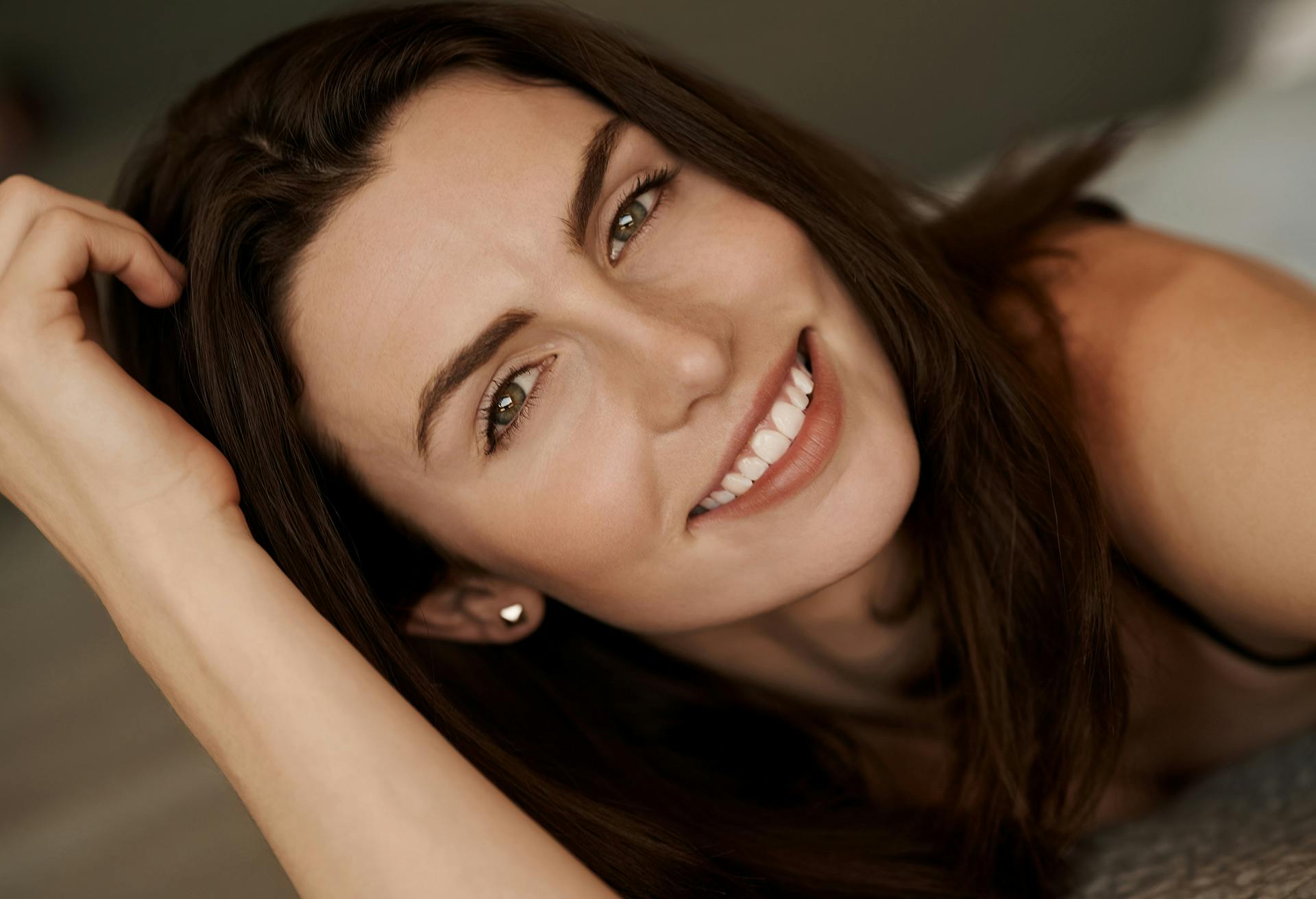 Woman with long dark hair smiling