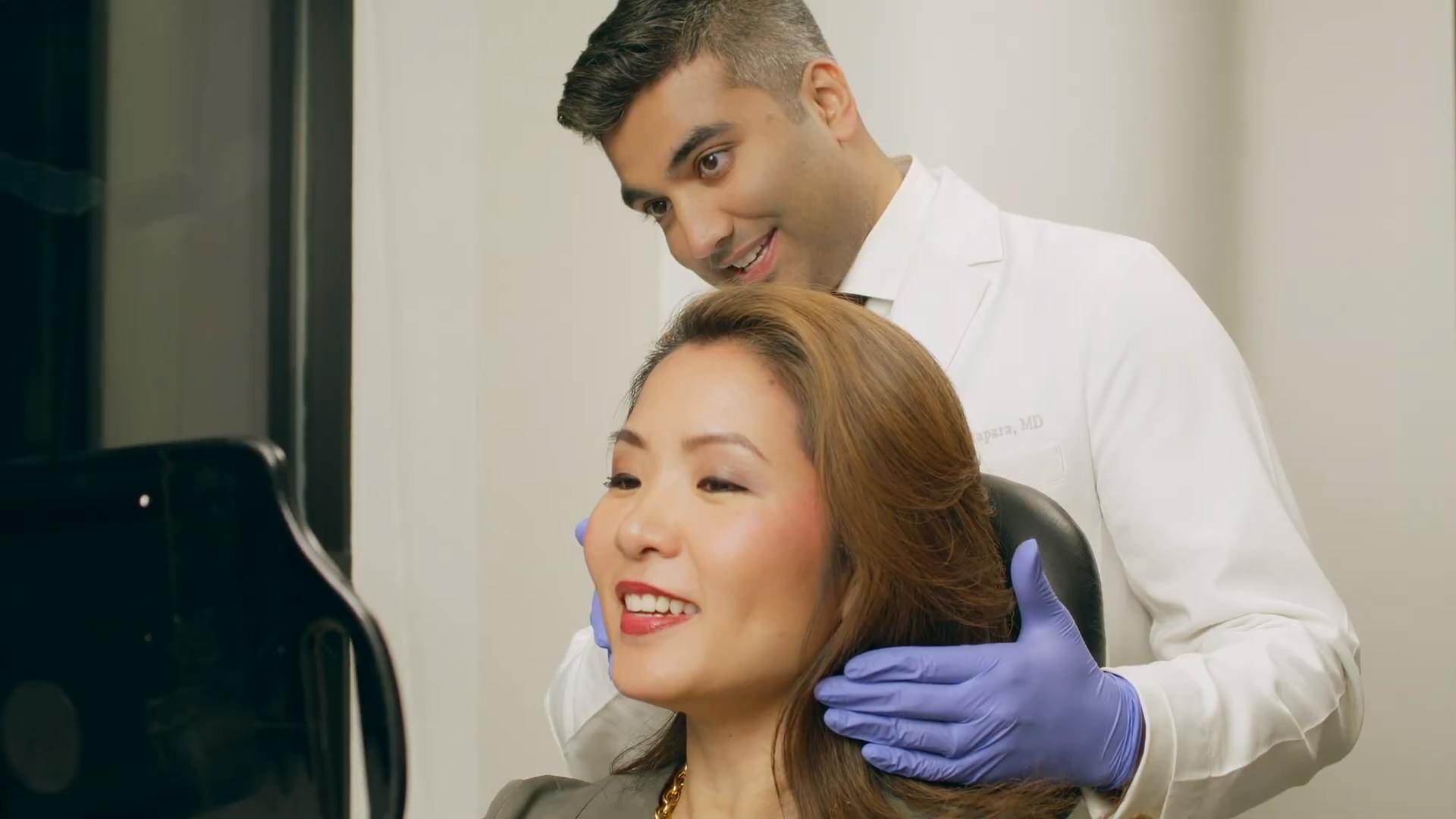 Woman Looking at her Hair Restoration Results