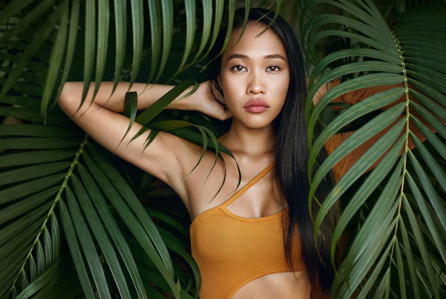 Woman Behind Palm Tree Leaves
