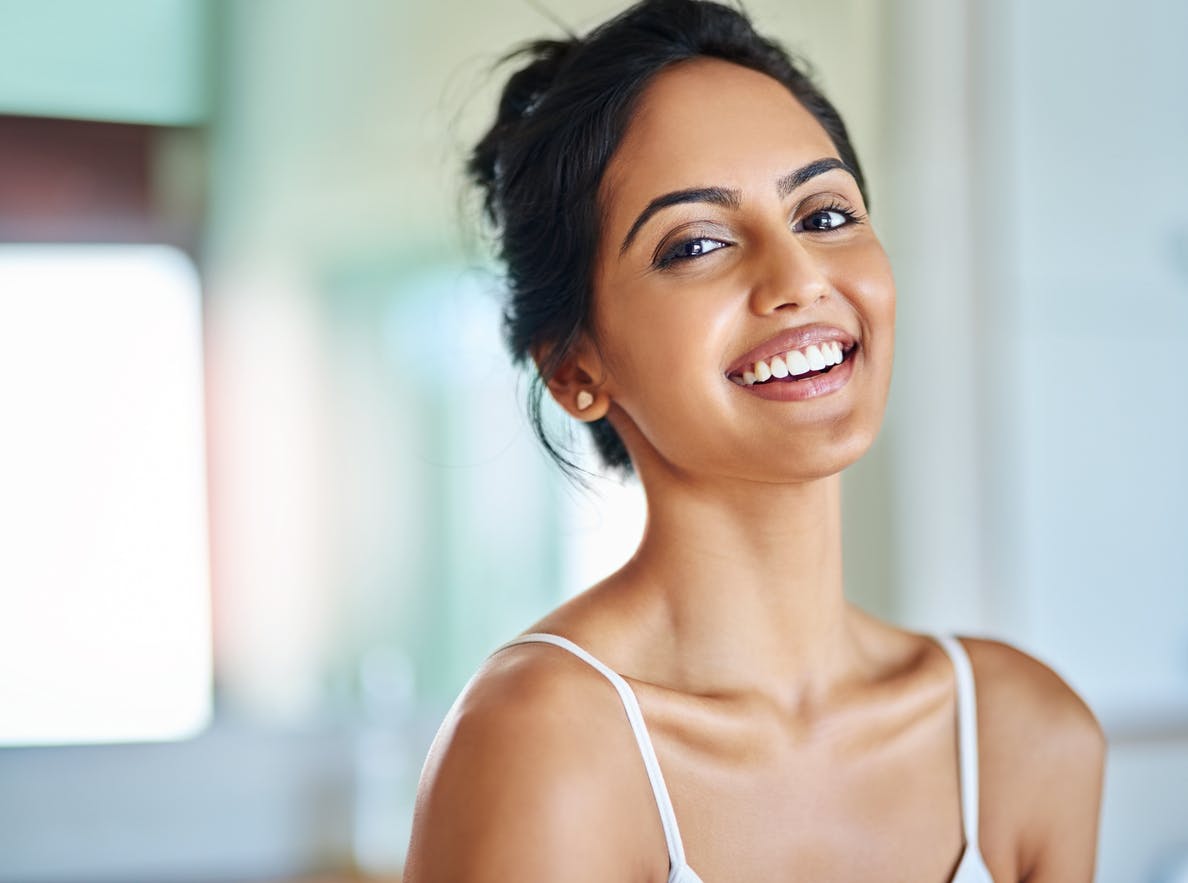 Woman with her hair up smiling