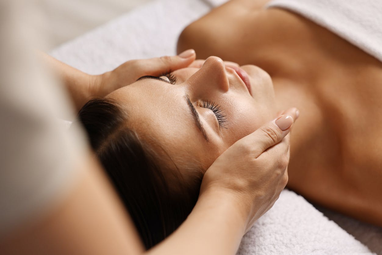 Woman laying down getting a facial treatment