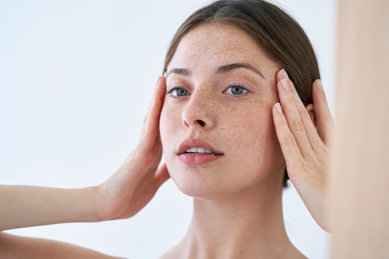 woman touching her face slightly