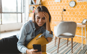 A woman staring at her phone, taking a quiz to figure out which university is right for her.