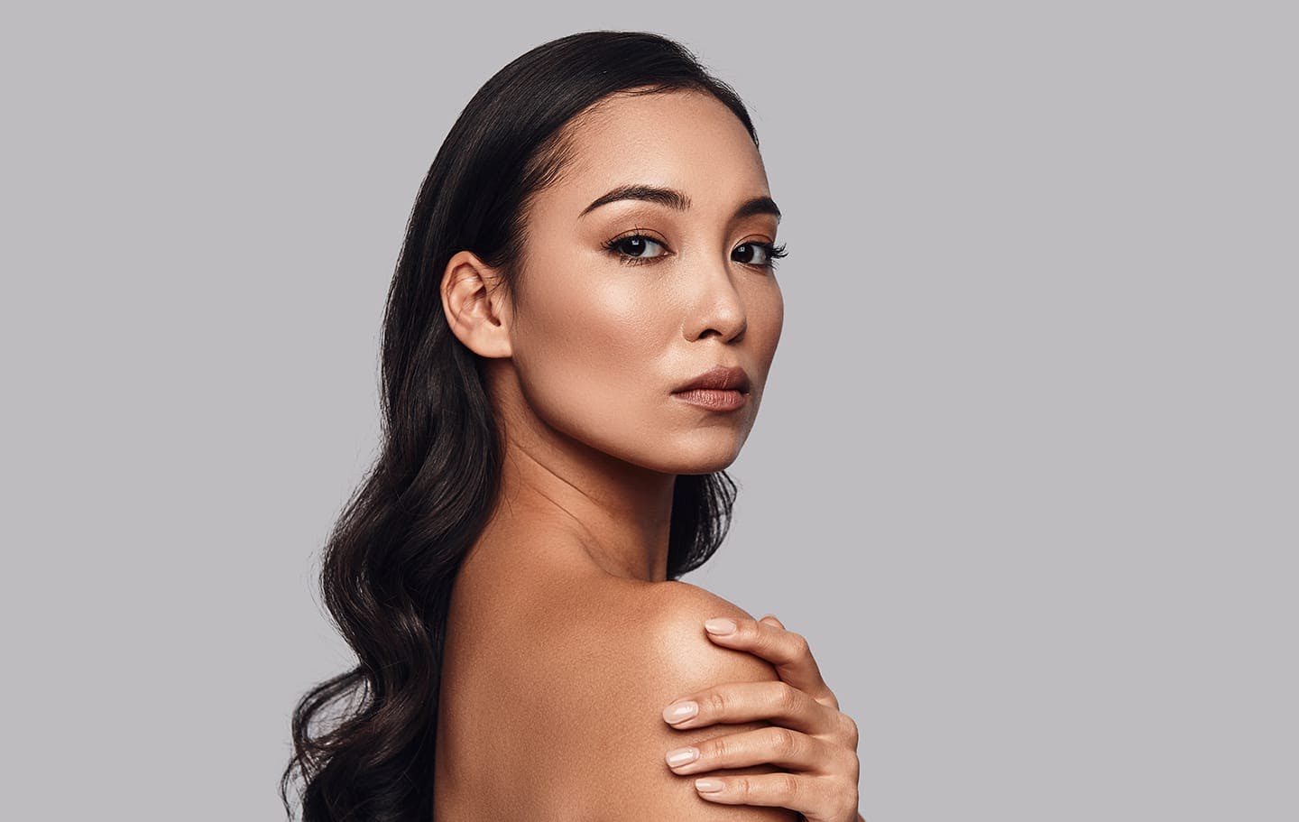 woman looking overbare shoulder
